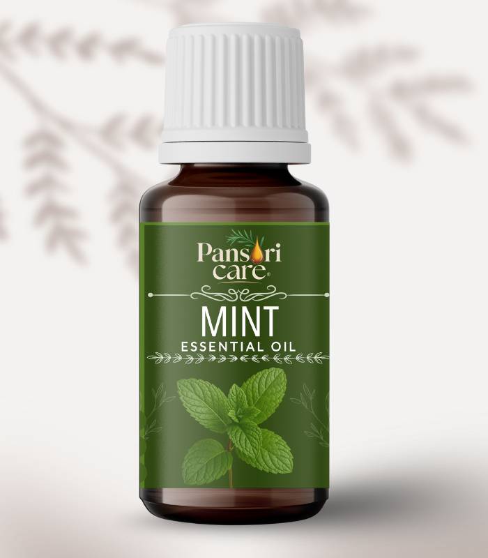 Pansari Care Mint Essential Oil bottle with fresh green spearmint leaves. Pansari Care Mint Essential Oil bottle with fresh green spearmint leaves.