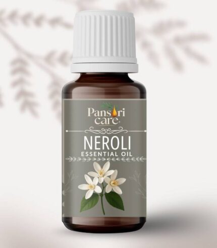 Pansari Care Neroli Essential Oil bottle with fresh white bitter orange blossoms.