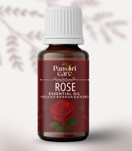 Pansari Care Rose Essential Oil bottle with fresh pink and red rose petals and flowers.