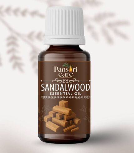 Pansari Care Sandalwood Essential Oil bottle with a few pieces of sandalwood and a small flower.