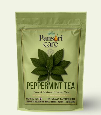 Pansari Care Peppermint Tea in a glass mug with a sprig of fresh mint.