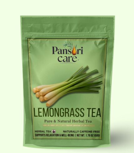Pansari Care Lemongrass Tea in a clear glass mug, with fresh lemongrass stalks and a slice of lemon.