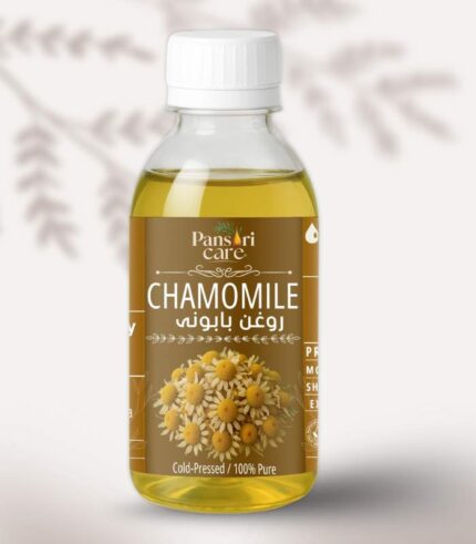 Pansari Care Chamomile Oil bottle with fresh chamomile flowers and a few drops of oil.