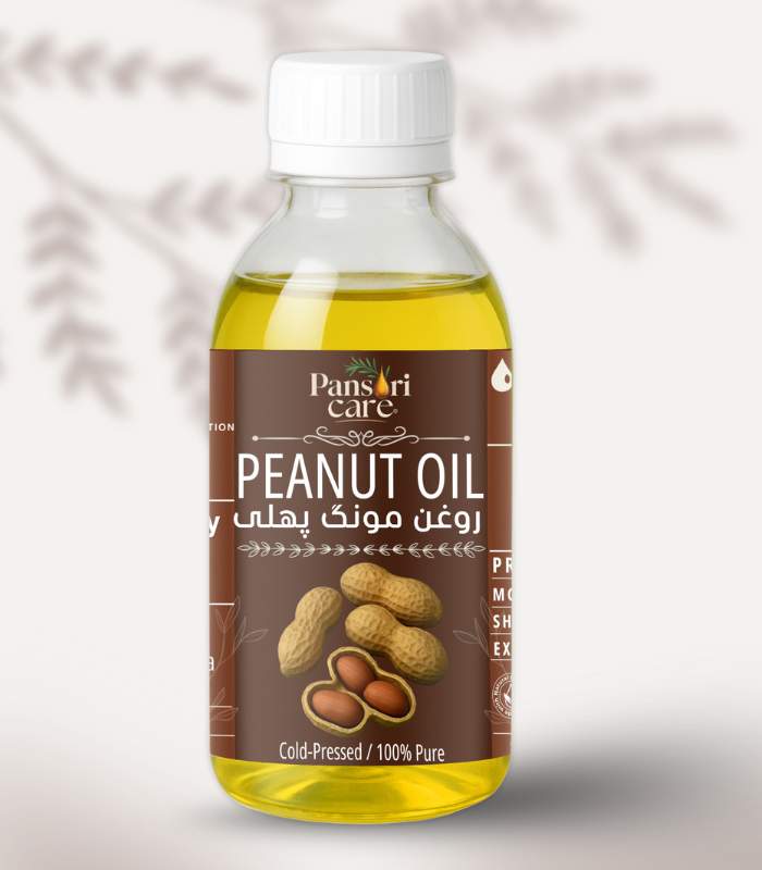 peanut Pansari Care Peanut Oil bottle with fresh peanuts in their shells and roasted peanuts.